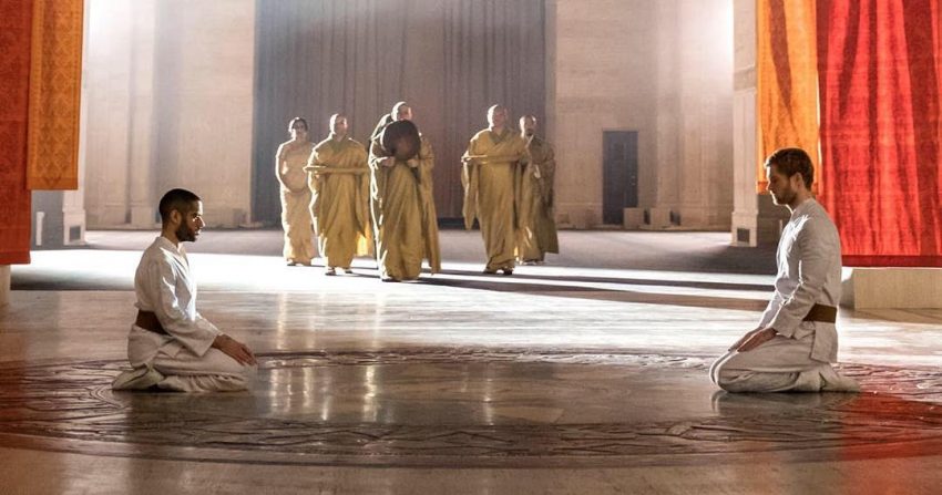 Davos and Danny kneeling during a ritual.