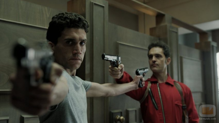 Berlin (Pedro Alonso) and Denver (Jaime Lorente) point guns at each other in Money Heist.